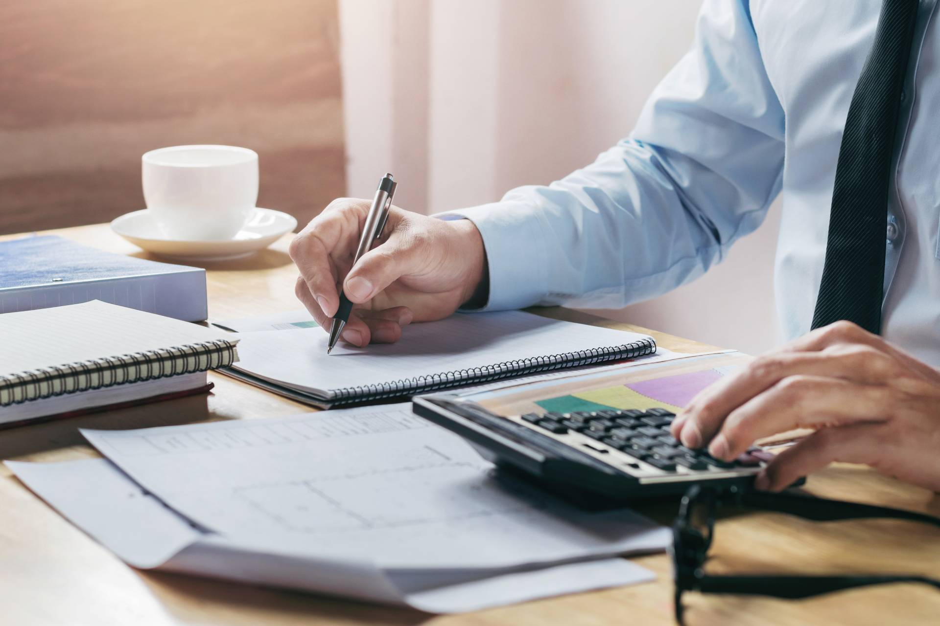 businessman-working-accountand-finance-with-using-calculator-pen-table-office(1)